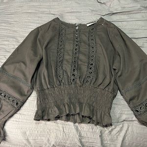 Cropped black top.  Size small. Revealing holes through front.